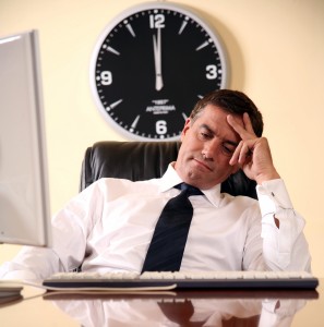 Businessman sitting at his desk lost in thought
